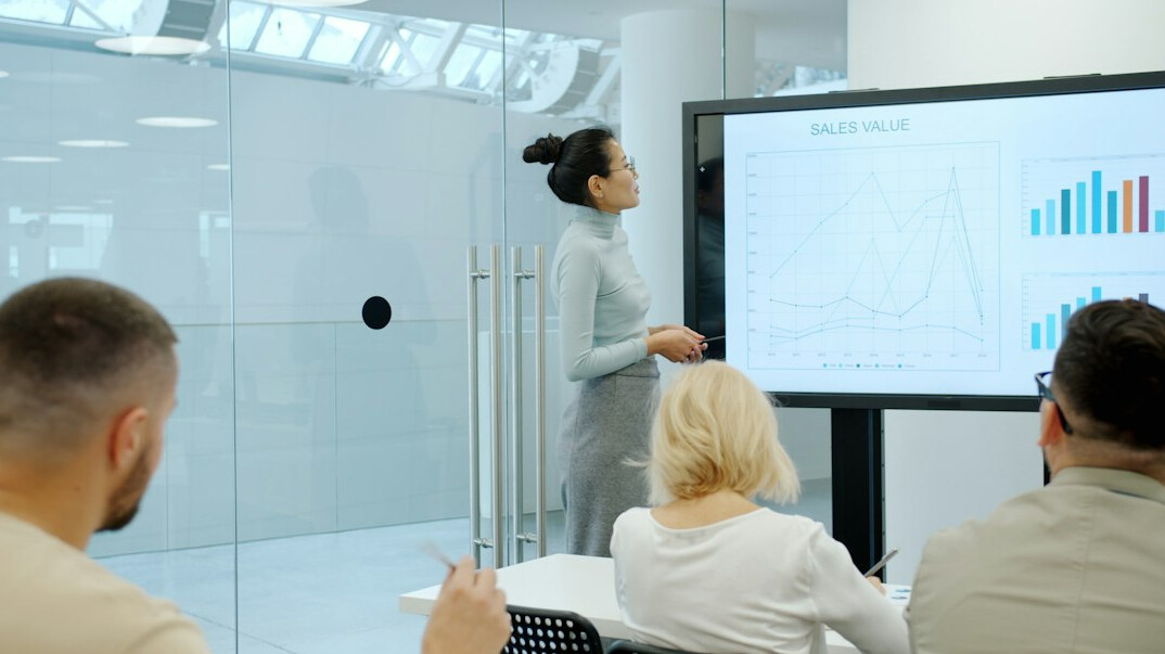 woman presenting to team